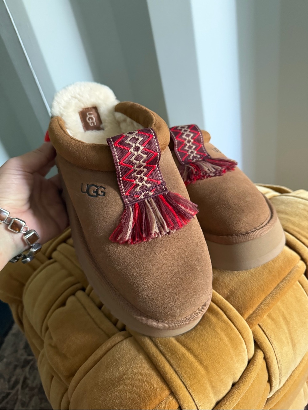 UGG Chestnut Suede Mules with Red Tassel Trim